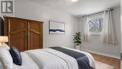 Bedroom featuring baseboards and wood finished floors - 