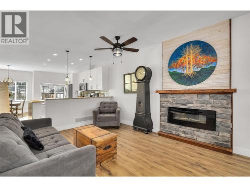 Living room, featuring a custom built artisan live edge wood mantle with real rock - 600 Sherwood Road Unit# 55, Kelowna, BC - Indoor Photo Showing Living Room With Fireplace