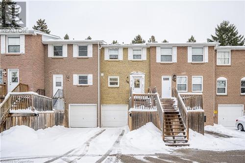 View of property featuring a garage, brick siding, and stairway - 212 Westcourt Place, Waterloo, ON - Outdoor With Facade