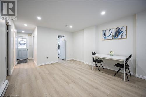 Office space featuring light wood-style floors, baseboards, a baseboard heating unit, and recessed lighting - 212 Westcourt Place, Waterloo, ON - Indoor