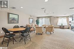 Dining room featuring light carpet, baseboards, visible vents, and a glass covered fireplace - 