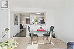 Dining area featuring tile patterned flooring, carpet flooring, and baseboards - 