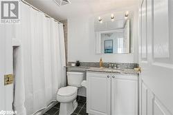 Full bath with curtained shower, tile patterned flooring, toilet, vanity, and visible vents - 