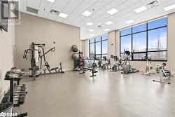 Gym with a paneled ceiling, baseboards, and visible vents - 