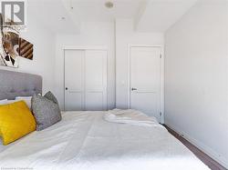 Bedroom featuring a closet, wood finished floors, and baseboards - 