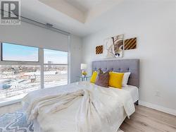 Bedroom with wood finished floors, visible vents, and baseboards - 