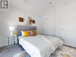 Bedroom featuring a closet and wood finished floors - 