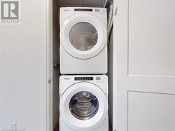 Laundry area with stacked washer and dryer and laundry area - 