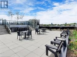 View of patio with outdoor dining area and a city view - 