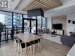 Dining space featuring expansive windows, visible vents, and wood finished floors - 