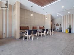 Kitchen featuring recessed lighting, a raised ceiling, decorative light fixtures, and tile patterned flooring - 