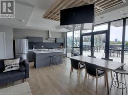 Dining room featuring light wood finished floors, visible vents, a wall of windows, and recessed lighting - 