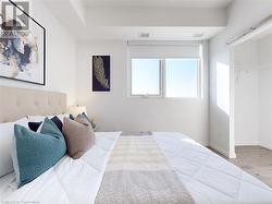 Bedroom with a closet, visible vents, baseboards, and wood finished floors - 