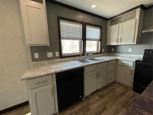 Including dish washer - E10 1545 Main Street E, Swan River, MB - Indoor Photo Showing Kitchen With Double Sink