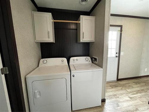 Laundry by the back door - E10 1545 Main Street E, Swan River, MB - Indoor Photo Showing Laundry Room