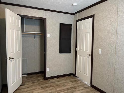 Bedroom #2, Large closet, HWT/ elect panel - E10 1545 Main Street E, Swan River, MB - Indoor Photo Showing Other Room