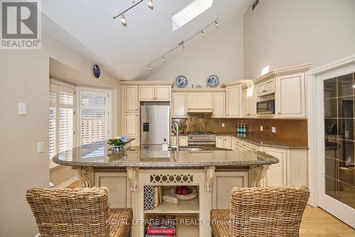 An attractive breakfast island. - 12 Brigantine Court, St. Catharines (Port Weller), ON - Indoor Photo Showing Kitchen