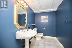 The 2-piece bathroom that services the basement. - 