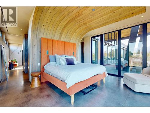 Primary Bedroom with Hemlock Wood arch feature - 4275 Todd Road, Kelowna, BC - Indoor Photo Showing Bedroom