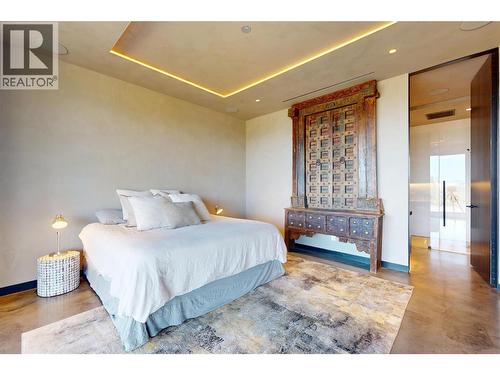 Second bedroom complete with a gorgeous 4 pc ensuite & heated towel rack - 4275 Todd Road, Kelowna, BC - Indoor Photo Showing Bedroom