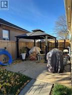 View of patio featuring grilling area, a gazebo, and fence - 