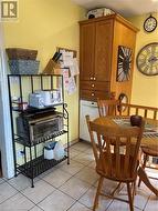 Dining room featuring light tile patterned floors - 