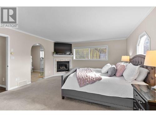 7115 Tronson Road, Vernon, BC - Indoor Photo Showing Bedroom With Fireplace