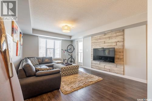 214 5301 Universal Crescent, Regina, SK - Indoor Photo Showing Living Room With Fireplace