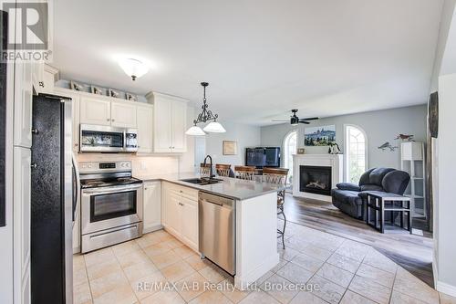 101 Rudy Avenue, East Zorra-Tavistock (Tavistock), ON - Indoor Photo Showing Kitchen With Fireplace