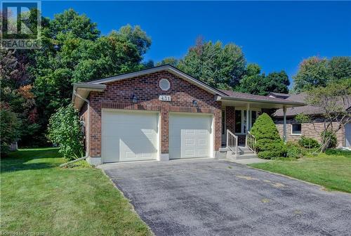 Ranch-style house featuring a front lawn, an attached garage, brick siding, and driveway - 431 Northlake Drive, Waterloo, ON - Outdoor