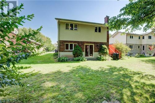 Back of house with brick siding, a lawn, and a chimney - 431 Northlake Drive, Waterloo, ON - Outdoor