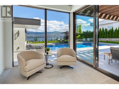 Sunny sitting area in primary bedroom - 2463 Thacker Drive, West Kelowna, BC - Indoor With In Ground Pool