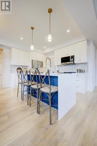 Photos of same floorpan previously built - 109 Thackeray Way, Minto, ON - Indoor Photo Showing Kitchen With Upgraded Kitchen