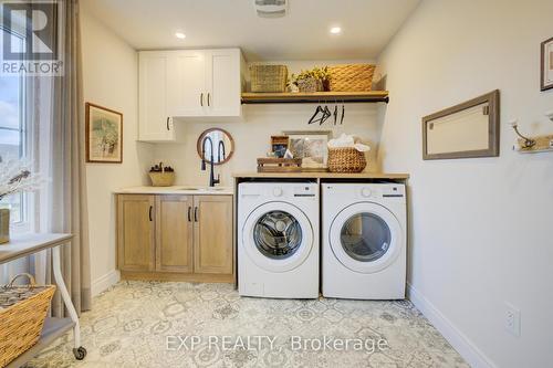 Photos of same floorpan previously built - 109 Thackeray Way, Minto, ON - Indoor Photo Showing Laundry Room