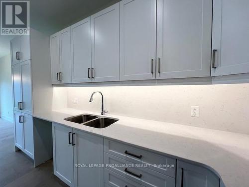 Kitchen with quartz backsplach - 22 Douglas Marshall Crescent, Brockville, ON - Indoor Photo Showing Kitchen With Double Sink
