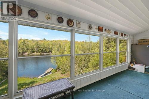 Sun room looking out on lake - 15 Labrash Lake Road, Whitestone, ON -  Photo Showing Other Room With Body Of Water