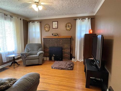 280 2Nd Avenue, Swan River, MB - Indoor Photo Showing Living Room With Fireplace