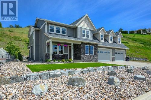 Very picturesque style home, crisp white trim, warm grey tone exterior and punch of color for a welcoming front door - 313 Baldy Place, Vernon, BC - Outdoor With Facade