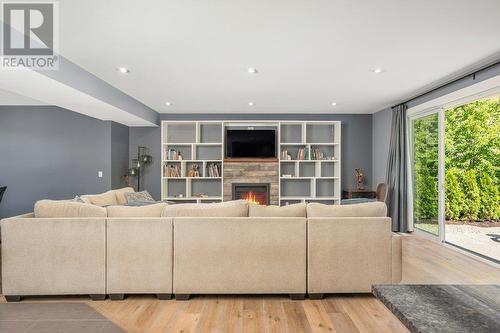 Extra wide patio doors offering a seamless flow to the outdoors - 313 Baldy Place, Vernon, BC - Indoor Photo Showing Living Room With Fireplace