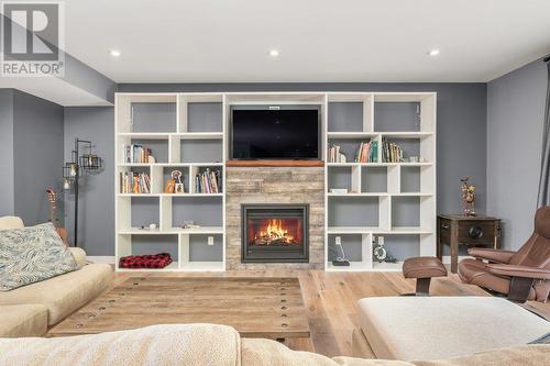 View from standing in the Kitchen (gas fireplace), built in entertainment unit - 313 Baldy Place, Vernon, BC - Indoor Photo Showing Living Room With Fireplace
