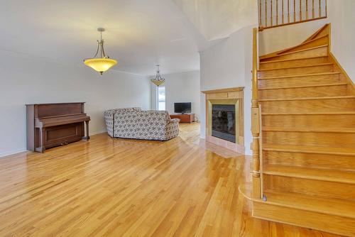 Living room - 49 Rue Des Arbres, Dollard-Des-Ormeaux, QC - Indoor With Fireplace