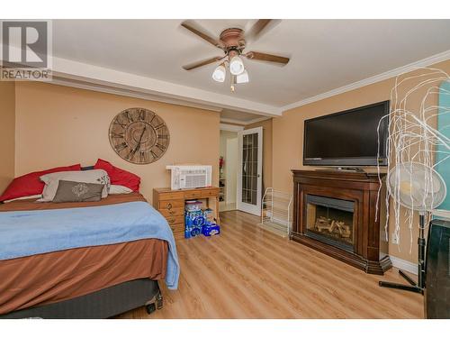 729 Stanley Avenue, Enderby, BC - Indoor Photo Showing Bedroom With Fireplace