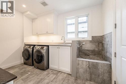 Washroom with washer and clothes dryer, cabinet space, and baseboards - 346 Lexington Road, Waterloo, ON - Indoor Photo Showing Laundry Room
