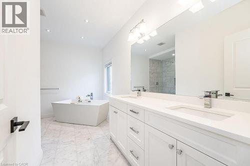 Full bathroom featuring tiled shower, a soaking tub, double vanity, marble finish floors, and recessed lighting - 346 Lexington Road, Waterloo, ON - Indoor Photo Showing Bathroom