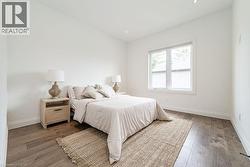 Bedroom with baseboards, recessed lighting, and wood finished floors - 