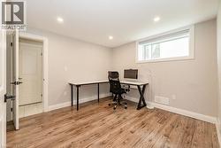 Home office featuring light wood-type flooring, baseboards, and recessed lighting - 