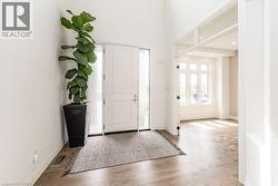Foyer featuring wood finished floors and baseboards - 