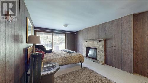 26 Hall Street, Gore Bay, ON - Indoor Photo Showing Bedroom With Fireplace