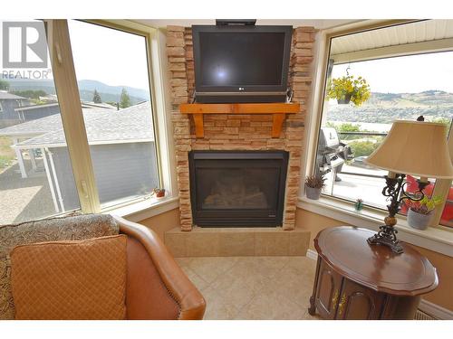 N/G Fireplace in family room - 9003 Cherry Lane, Coldstream, BC - Indoor Photo Showing Living Room With Fireplace