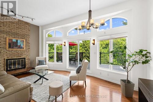 Living Room looking onto huge balcony - 4 - 1011 Prince Of Wales Drive, Ottawa, ON - Indoor Photo Showing Living Room With Fireplace